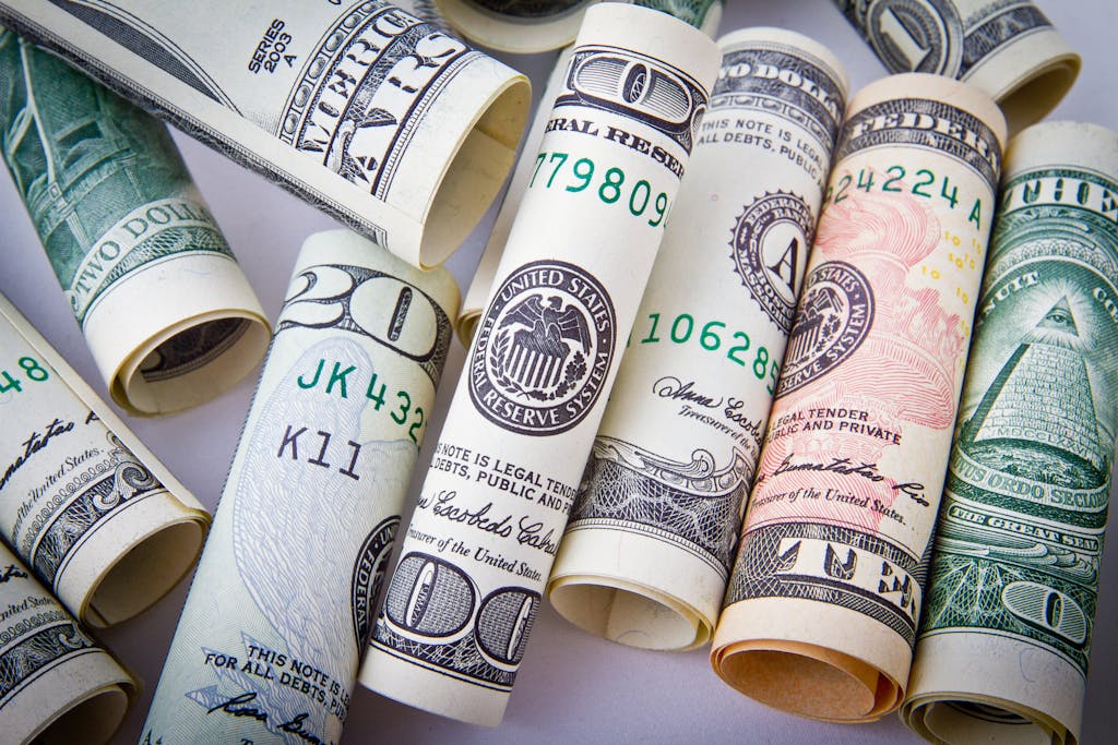 Close-up of rolled US dollar bills symbolizing wealth, financial success, and currency.